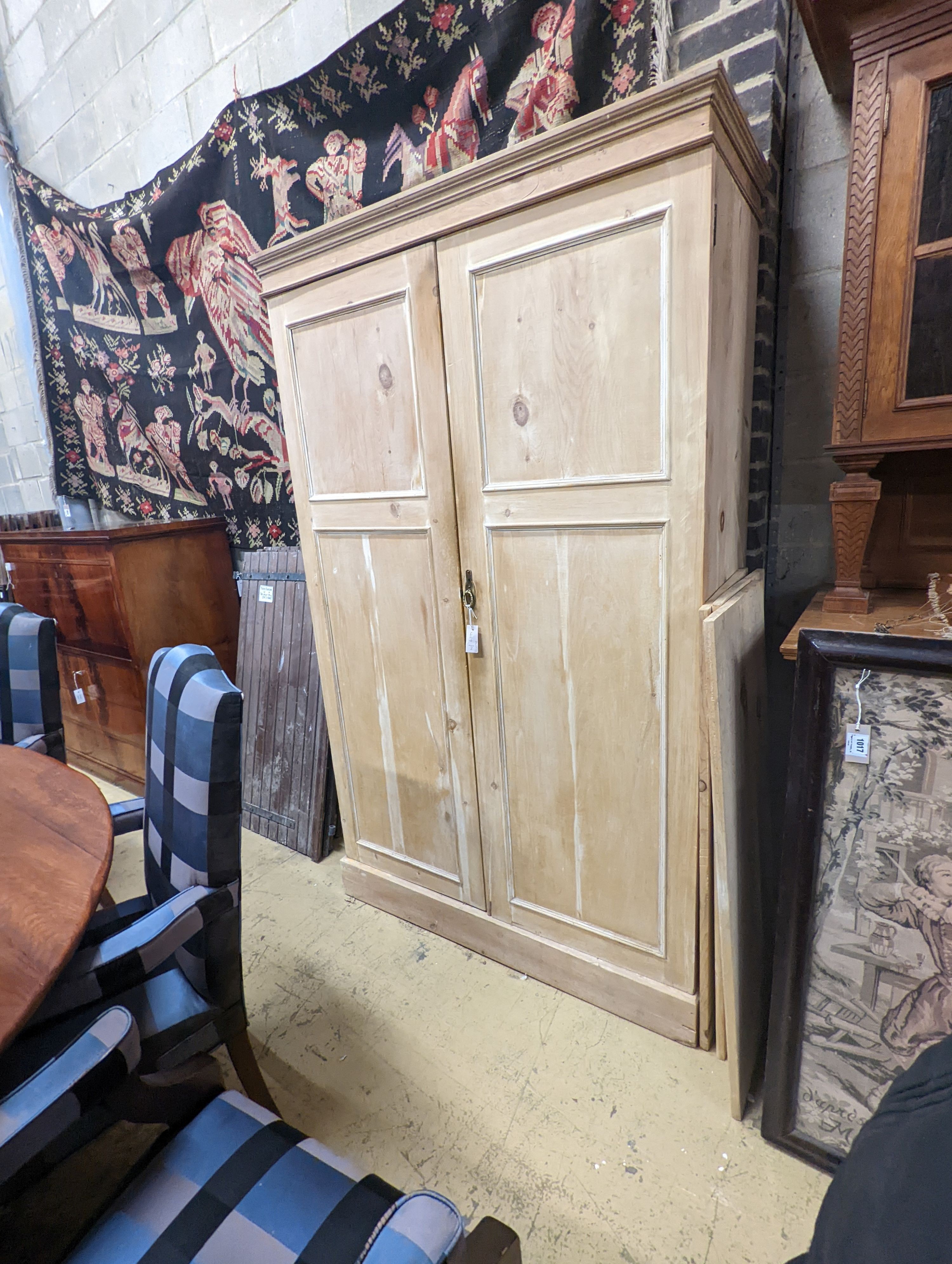 An early 20th century stripped pine two door press cupboard, width 120cm, depth 52cm